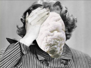 black and white photo of a women's head and shoulder and her hand on her forehead.  Her face is covered by a clouds superimposed over her face.