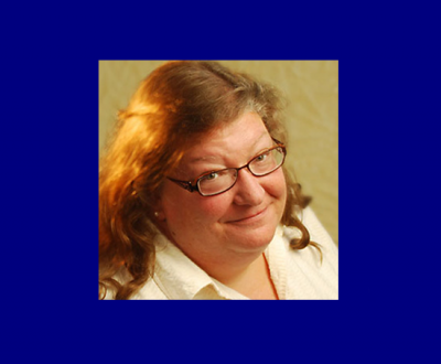 Kathy Rudy photo, reddish brown hair with glasses white shirt