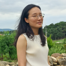 Soyi Kim, Asian with glasses and black straight hair and white sleeveless blouse